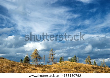 Heaven with clouds and trees on the hills
