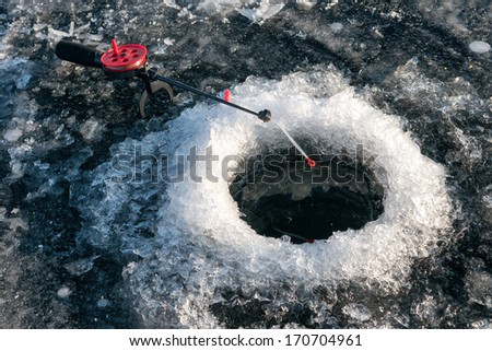 Little winter fishing rod in the hole