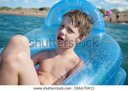 Boy swimming in inflatable boat