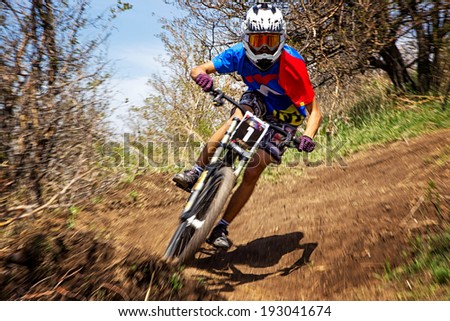 ALMATY, KAZAKSTAN - APRIL 27, 2014: Unknown rider in action at Mountain Bike sports event Downhill Koktybe.