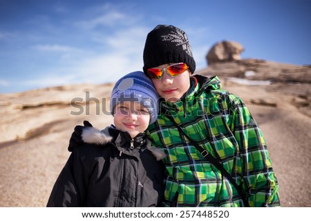 Two brothers early spring in desert mountains Bektau-Ata, Kazakhstan