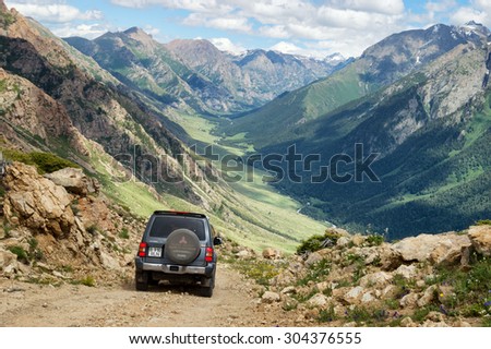 ALMATY REGION, KAZAKHSTAN - JULE 08, 2013: Jeep on a dangerous dirt road in the Kora gorge in Dzungarian Alatau.
