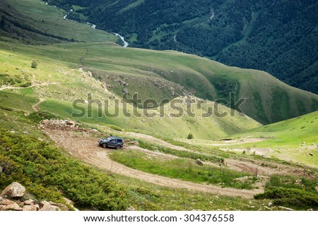 ALMATY REGION, KAZAKHSTAN - JULE 08, 2013: Jeep on a dangerous dirt road in the Kora gorge in Dzungarian Alatau.