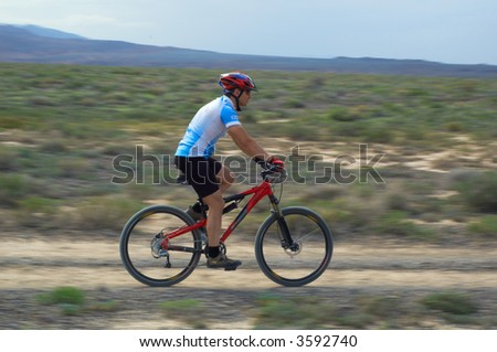 Mountain biker on old road in desert