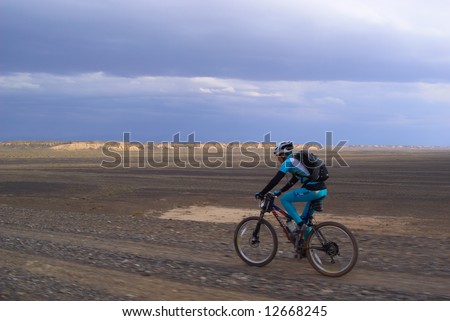 Mountain biker on old desert road