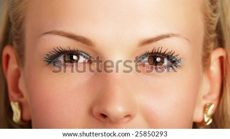 A beautiful blonde face with huge brown eyes close-up