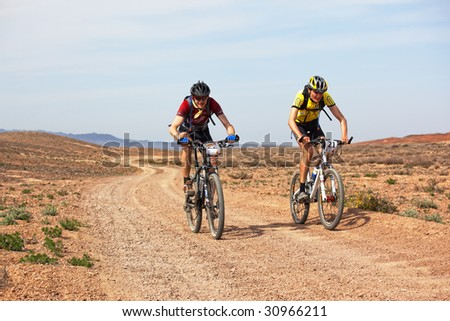 ALMATY, KAZAKHSTAN - MAY 1: Vladimar Philipchuk (N22) and Dmitry Rakhimkulov (N21) in action at Adventure mountain bike marathon in desert \
