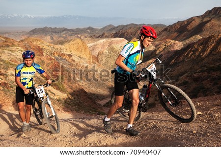 ALMATY, KAZAKHSTAN - May 1: S.Satylbaev (N14) and  N.Janbyrbayev (N15) in action at Adventure mountain bike cross-country marathon in desert \