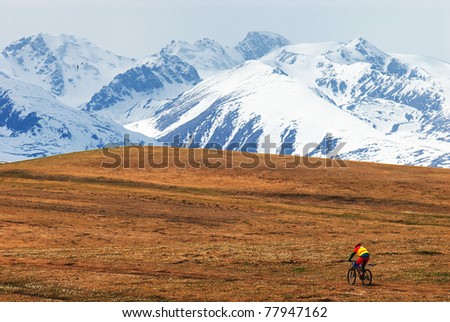 Mountain biker in desert mountains, Kazakstan