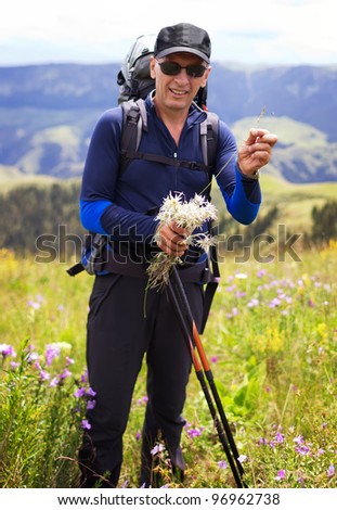 Hiker stopping to smell the wildflowers