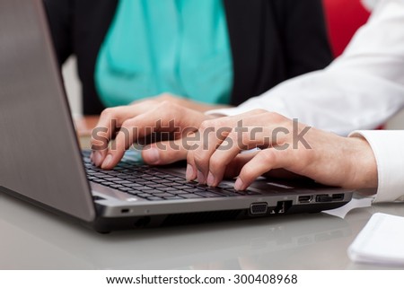 woman typing on the computer