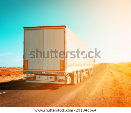 freight truck driving to sunset