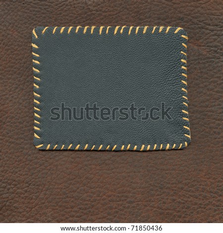 Leather tag on the background of suede