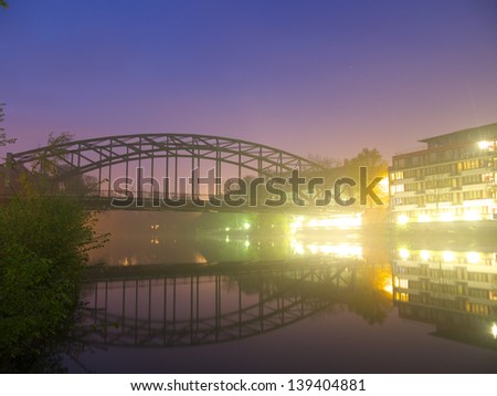 mist on a river at dusk in a german city