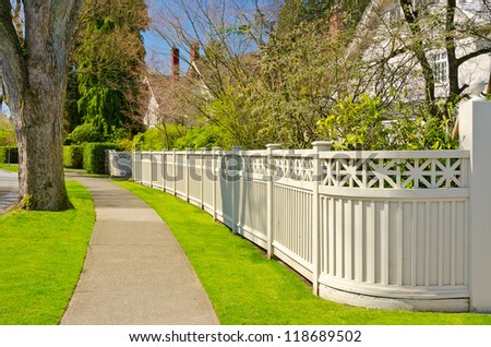 A perfect neighborhood. Houses behind fences in suburb at Spring in the north America