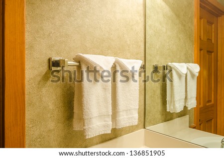 Fragment of a luxury bathroom with a towel on a hanger