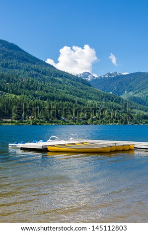 Reflection in water of mountain lakes and boats. Alta lake in Whistler, Vancouver, Canada. Beauty world.