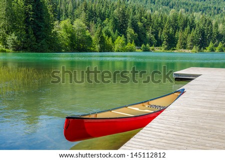 Reflection in water of mountain lakes and boats. Alta lake in Whistler, Vancouver, Canada. Beauty world.