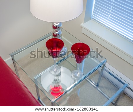 Interior design with lamp and two glasses on end table