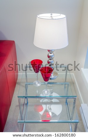 Interior design with lamp and two glasses on end table