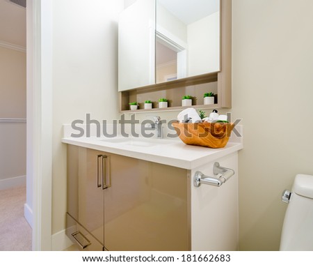 Fragment of luxury bathroom with a sink and wooden cabinet