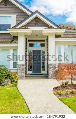 A nice entrance of a luxury house over outdoor landscape