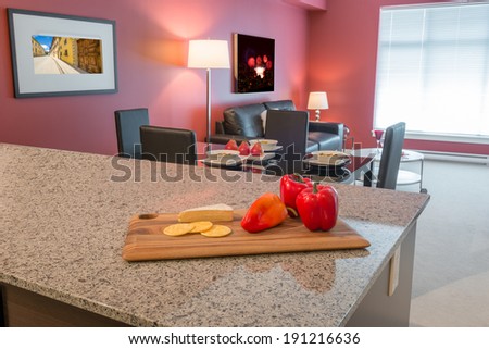 interior of red dining room and kitchen with red pepper on the table