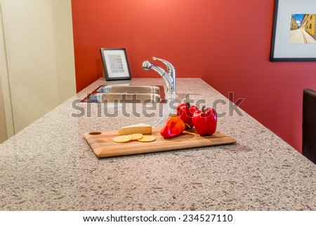 interior of red dining room and kitchen with red pepper on the table