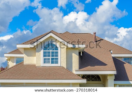 The roof of the house with nice window.