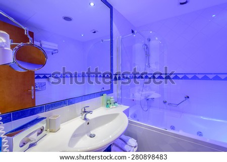 Fragment of a luxury bathroom in blue light.