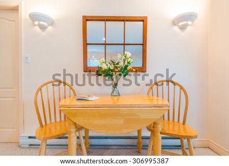 Table with flowers and two chairs. Interior design of a luxury living room.