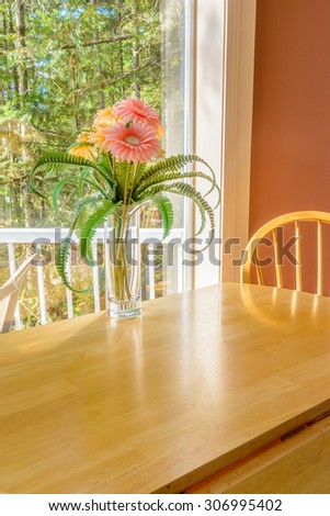 Table with flowers and a chair. Interior design of a luxury living room.