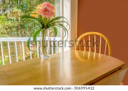Table with flowers and a chair. Interior design of a luxury living room.
