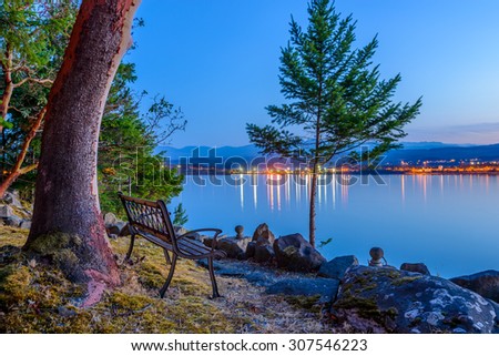 Tranquil sunset and evening illuminations of the beautiful town of Nanaimo on Pacific Ocean in Vancouver, Canada.