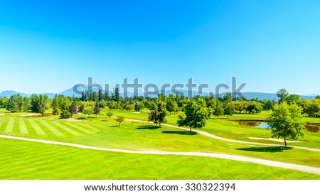 Wide and Top View at Golf course with gorgeous green and pond.
