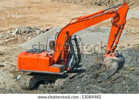 Backhoe loader excavating for home construction site