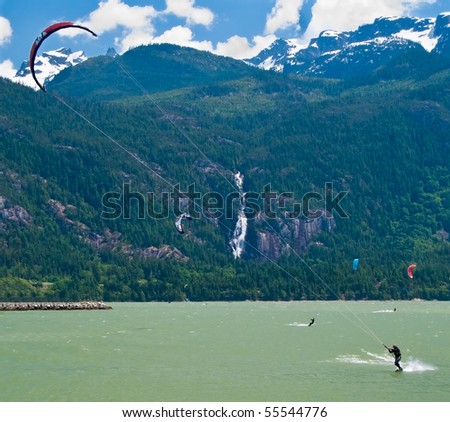 kite boarding on a beach of sea, sportsmen in action
