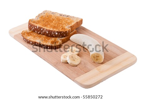 Two slices of bread and banana on wooden board, isolated on white background.