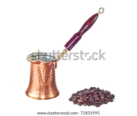 Turkey Cezve with coffee beans isolated on white background.