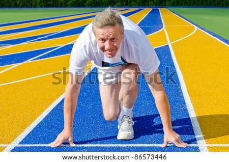 athletic man on track starting to run