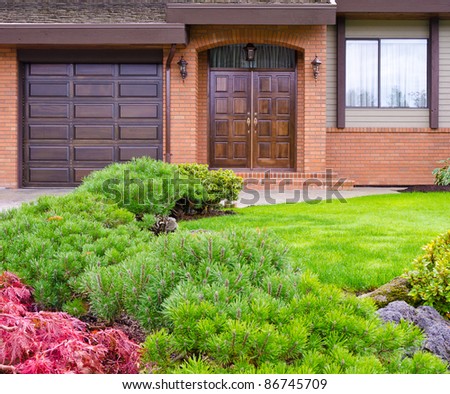 Entrance of a house with garage door and window over beautiful outdoor landscape