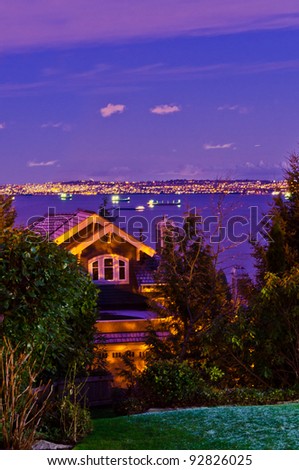 Fragment of a luxury house over fantastic night ocean view in West Vancouver, Canada.