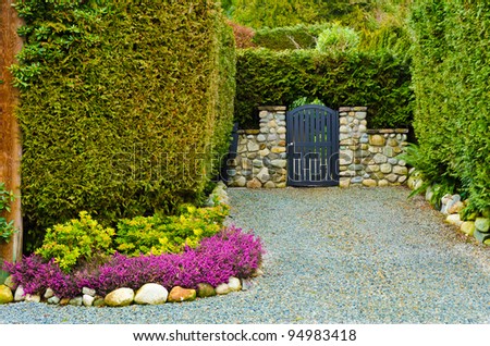 Beautiful gate over fantastic outdoor landscape with stone wall in Vancouver, Canada.