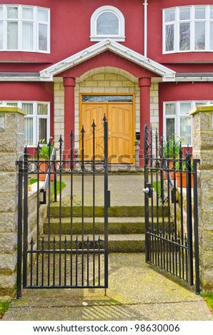 Entrance of a house with open gate.
