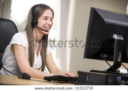 Happy female employee answers the phone