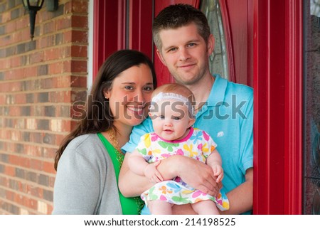 Young Family Standing Outside on the Porch