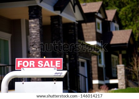 For sale signs in an upscale residential neighbourhood