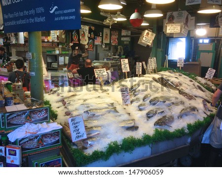SEATTLE, WA - JULY 20: Pike Place Fish Market Co, July 20, 2013, the world famous fish market at Pike Place Market in Seattle. Established in 1965 it is famous for its employees throwing fish.