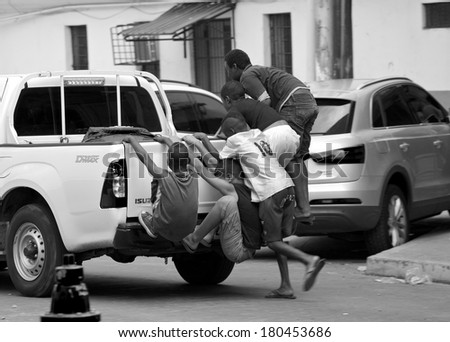 PANAMA CITY, PANAMA - JANUARY 18, 2014: Unidentified children riding on back of truck in streets of Casco Viejo the historic district of Panama City which was designated a World Heritage Site in 1997