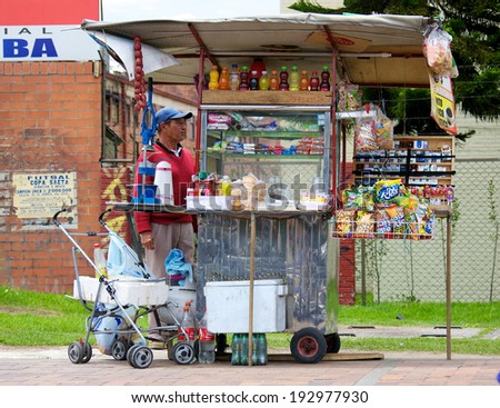 BOGOTA, COLOMBIA - MAY 04, 2014: Vendor selling food drinks and snacks along a busy street in Bogota. Street vendors are very common in the streets of Bogota.